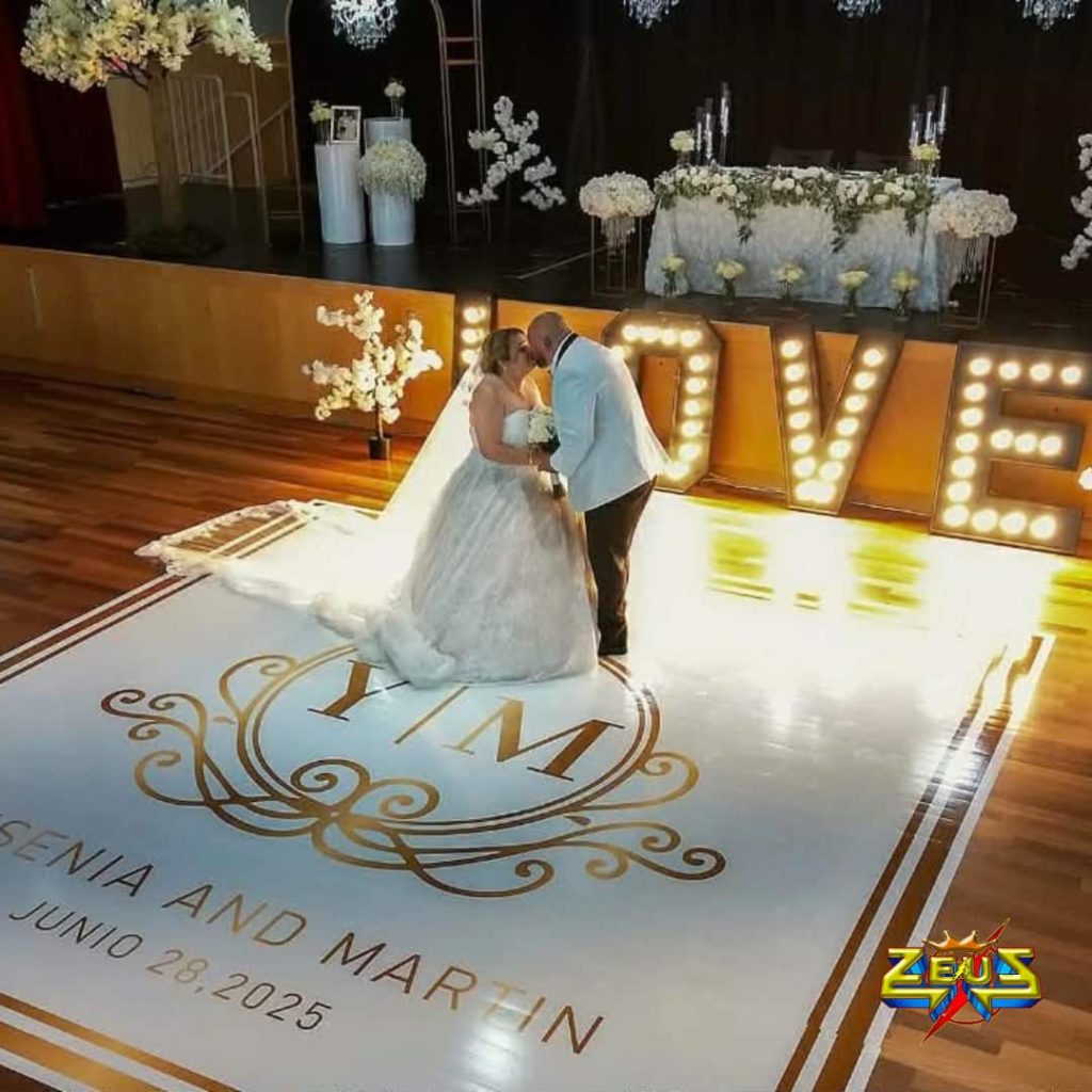 Bride and groom celebrating their wedding reception with professional DJ entertainment, elegant uplighting, LED dance floor lighting, and luxury wedding setup in Columbus, Indiana.